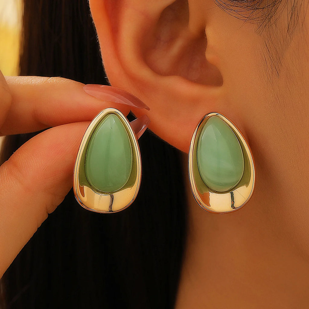 Earrings with a light green teardrop silhouette
