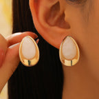Earrings with a white teardrop silhouette