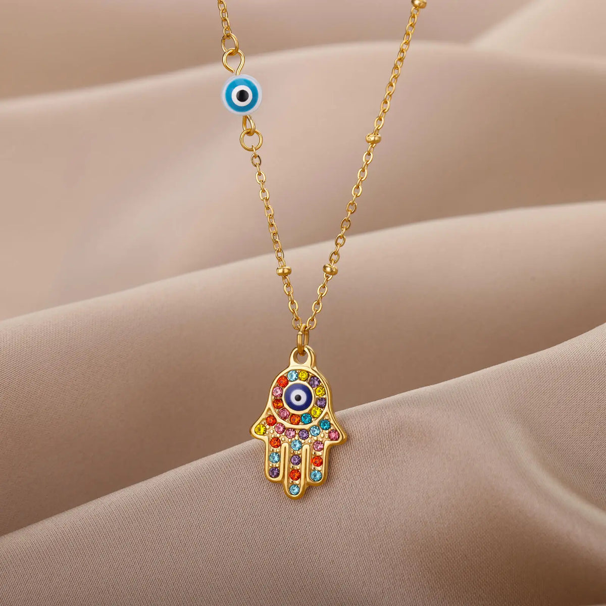 Necklace with multicolored Arabic evil eye protection pendant and Fatma's hand in gold