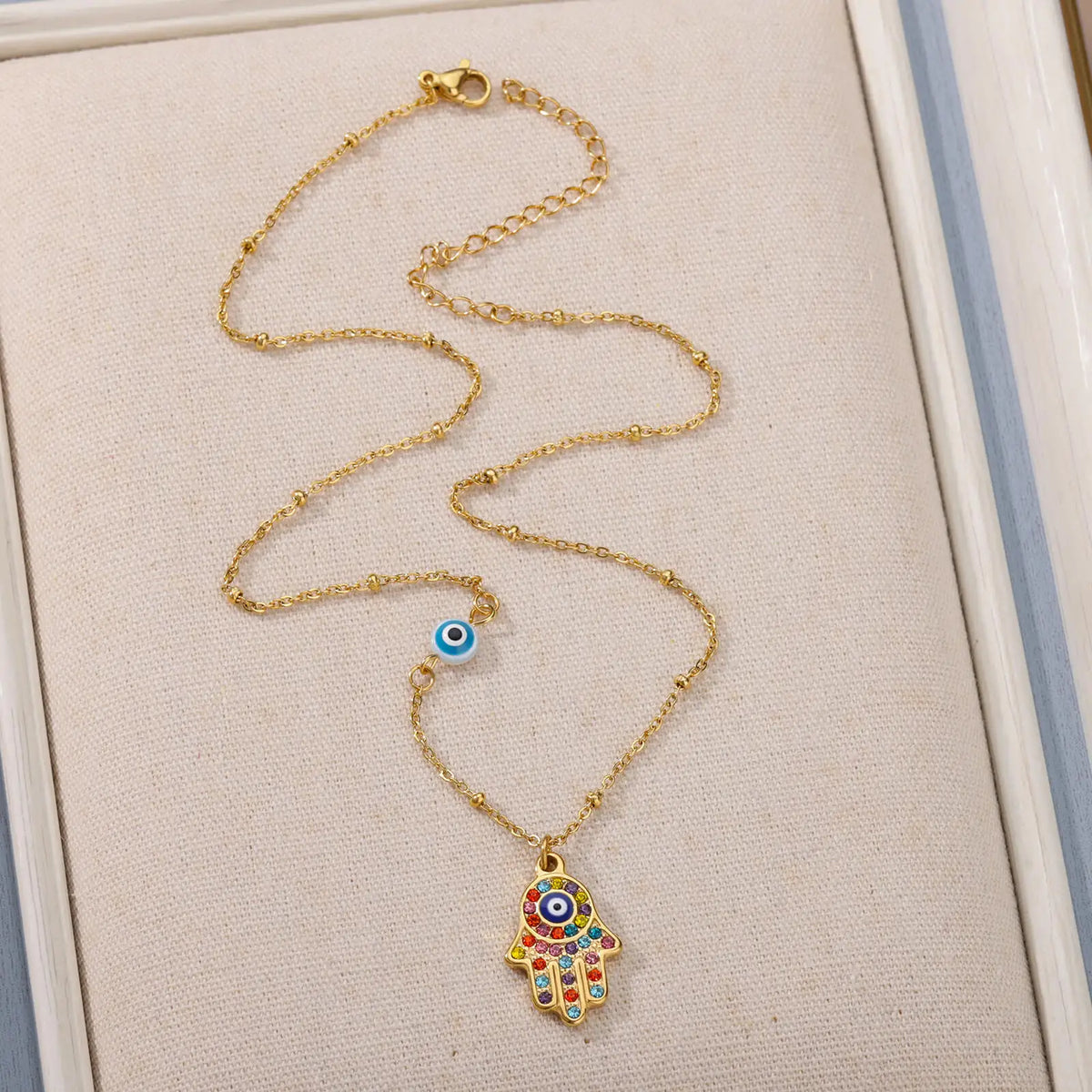 Necklace with multicolored Arabic evil eye protection pendant and Fatma's hand