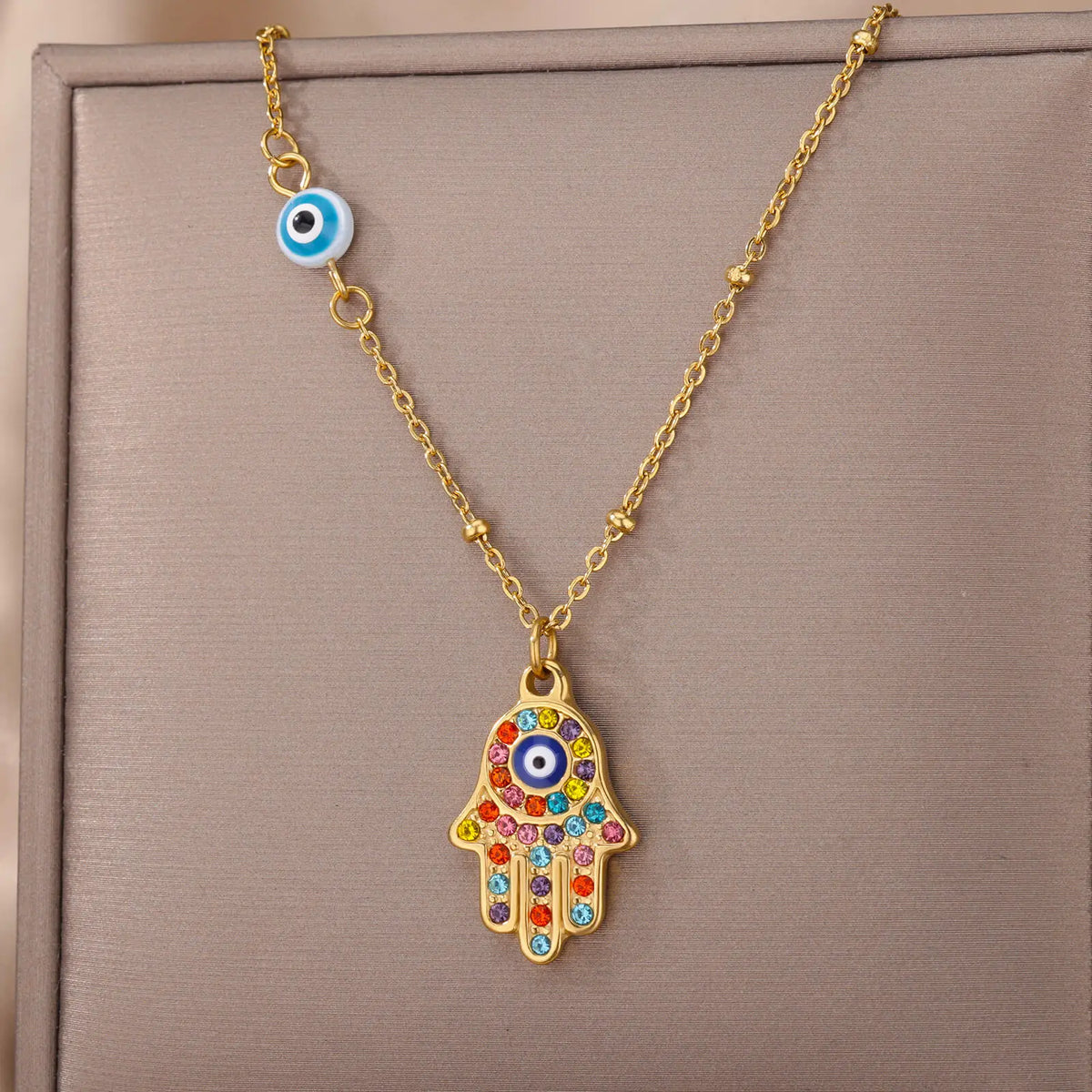 Necklace with multicolored Arabic evil eye protection pendant and Fatma's hand in gold
