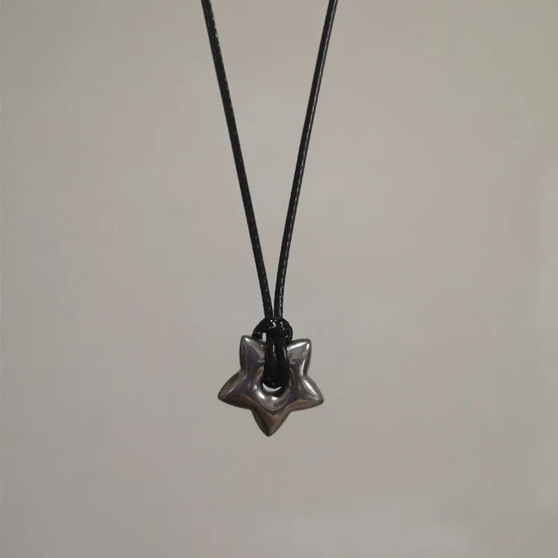 Cord necklace with hollow star pendant