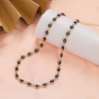 Choker necklace adorned with multiple black blue eye charms