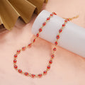 Choker necklace adorned with multiple light red blue eye charms