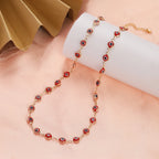 Choker necklace adorned with multiple dark red blue eye charms