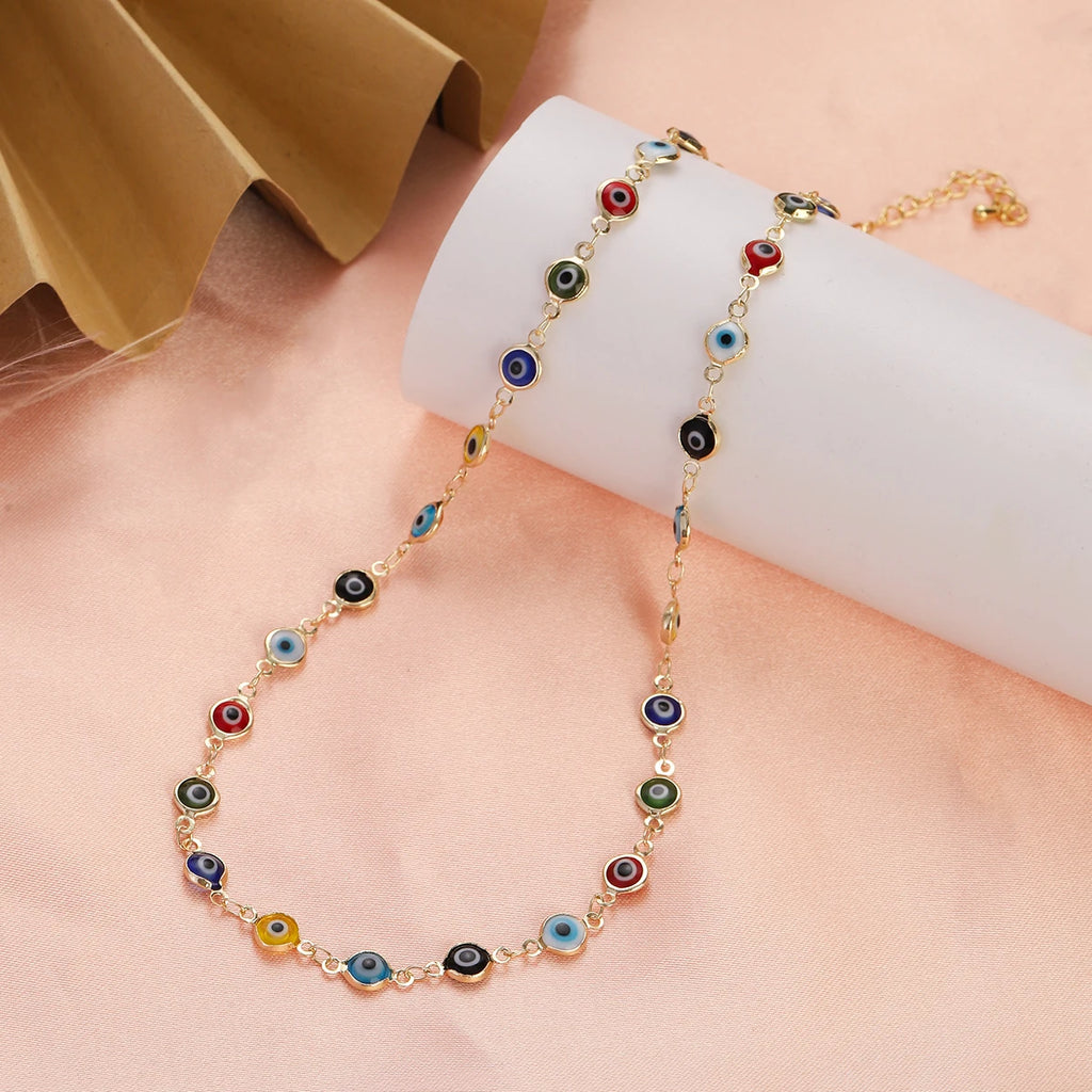 Choker necklace adorned with multiple multicolored neutral-tone blue eye charms