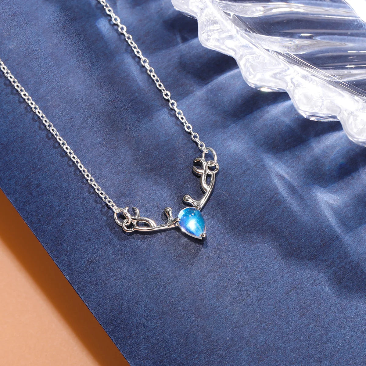 Necklace with antler wood pendant and iridescent blue moonstone